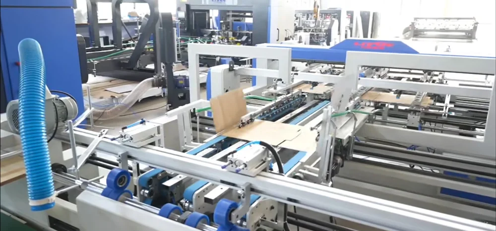 Folder gluer belt tension adjustment mechanism